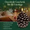 A pinecone-shaped LED candle with a gift box in the background, set against a festive, blurred background. Produktbild-Vorschau