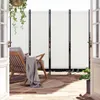 A balcony with a rocking chair, a blanket, and a screen divider. Produktbild-Vorschau