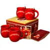 A set of red Feuerzangentassen (mulled wine mugs) with a box and coasters. Produktbild-Vorschau