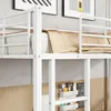 A close-up view of a white metal bunk bed with a tan blanket on the mattress. There are also some small storage containers and accessories attached to the bed frame. Anteprima dell’immagine prodotto