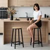 A woman is sitting on a bar stool in a modern kitchen. Náhled obrázku produktu