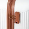 A close-up shot of a TSA-approved combination lock and zipper on a white suitcase. Produktbild-Vorschau
