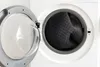A washing machine with its door open, revealing a dark gray rug inside. Náhled obrázku produktu