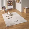 A child's room with a rug, chair, and shelving unit. Produktbild-Vorschau