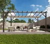 An outdoor patio area with a pergola, seating, and a coffee table. Podgląd zdjęcia produktu