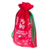 A red Christmas gift bag with green ribbon and white Christmas-themed illustrations. Produktbild-Vorschau