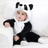 A baby wearing a panda costume sits on a white couch. Produktbild-Vorschau