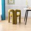 A pair of olive-colored velvet chairs are shown in a room with a table and a blue curtain. Voir les images du produit