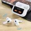 A pair of white wireless earbuds and their charging case are displayed on a wooden surface, with a smartphone in the background. Voir les images du produit