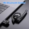 A black Bluetooth headset and its USB adapter are placed on a dark surface next to a laptop keyboard. Produktbild-Vorschau