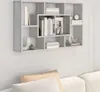 A grey wooden shelf unit mounted on a white wall, filled with books and decorative items. Below the shelf, part of a white sofa with beige and white cushions is visible. Voir les images du produit