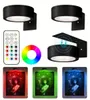 Schwarze runde LED-Wandleuchten mit Fernbedienung und Farbrad, die Kunstwerke in Rot, Grün und Blau beleuchten Náhled obrázku produktu