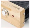 A close-up view of a raclette grill's wooden housing, showing a control knob, an indicator light, and the brand name. Produktbild-Vorschau