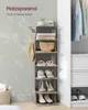 A tall, narrow shelving unit displaying shoes, a bag, and books, with clothes hanging in the background. Produktbild-Vorschau