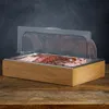 A chilled serving platter filled with various types of sliced meats, displayed on a wooden table against a dark background. Náhľad obrázku produktu