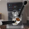 Close-up of a coffee machine portafilter being filled with coffee grounds, with a tamper hovering above. Produktbild-Vorschau