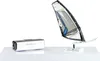 A silver digital camera and a miniature windsurfing sail are displayed on a white surface against a white background. Náhled obrázku produktu