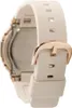 A close-up side view of a white and rose gold watch. Voir les images du produit