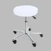 A white round stool cover on a rolling stool.