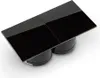 A black electrical outlet with four square buttons, mounted on two cylindrical bases. Produktbild-Vorschau