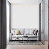 A modern living room with a gray sofa, coffee tables, and decorative pillows in front of a white paneled wall. Produktbild-Vorschau