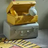 Two metal storage boxes stacked on top of each other, with a stuffed toy and a bottle inside the top box. Podgląd zdjęcia produktu