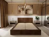 A modern bedroom with a brown upholstered bed frame and slatted base, flanked by nightstands and artwork on the wall. Podgląd zdjęcia produktu