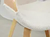 Close-up of a chair seat with a textured cream fabric and light wood frame. Produktbild-Vorschau