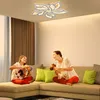 A mother and daughter are playing with dolls on a couch in a living room, illuminated by a decorative ceiling light. Náhled obrázku produktu