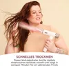 A woman is drying her hair with a white hairdryer. Voir les images du produit