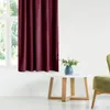 A burgundy curtain is shown next to a window, with a small white table and a green chair in the foreground. Produktbild-Vorschau