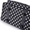 Close-up view of the base of a black and white polka dot bag. Produktbild-Vorschau