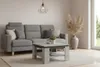 A living room scene featuring a couch and coffee table. Podgląd zdjęcia produktu
