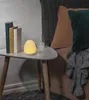 A bedside table with books, a lamp, and a glass of water. Produktbild-Vorschau