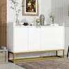 A white sideboard with a gold metal frame, decorated with a painting, vase, and small figurines. Anteprima dell’immagine prodotto