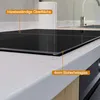A close-up view of a modern kitchen countertop with an induction hob. Produktbild-Vorschau