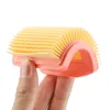 A hand holding a pink and yellow air filter. Náhled obrázku produktu