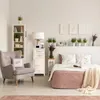 A bedroom scene with a bed, armchair, and storage unit. Náhľad obrázku produktu
