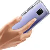 A hand holding a transparent phone case on a white background. Produktbild-Vorschau