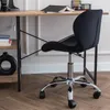 A black office chair is shown next to a wooden desk. Produktbild-Vorschau