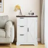 A white storage cabinet with a dark brown top, featuring three drawers on the left and a barn-style door on the right, placed next to a sofa. Anteprima dell’immagine prodotto