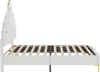 Side view of a white bed frame with a decorative, tiered headboard and gold accents on the legs. Náhľad obrázku produktu