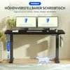 A black height-adjustable desk with two monitors, a keyboard, and accessories, set in a home office environment. Náhled obrázku produktu
