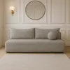 A modern living room setting with a sofa, wall light, and mirror. Produktbild-Vorschau