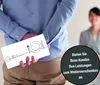 A man is hiding a gift voucher behind his back, with a woman blurred in the background. A dark circular overlay contains text. Produktbild-Vorschau