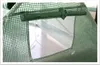 Close-up of a green mesh greenhouse cover with a clear window. Náhľad obrázku produktu
