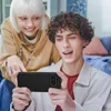 Two young people are looking at a smartphone held by one of them. Náhled obrázku produktu
