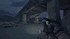 A first-person perspective of someone holding a handgun under a concrete overpass at dusk. Produktbild-Vorschau