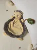 A plush hedgehog toy is placed on a textured cream blanket, next to a white pillow. Anteprima dell’immagine prodotto