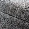 A close-up view of a folded gray carpet with a textured, ribbed pattern. Produktbild-Vorschau